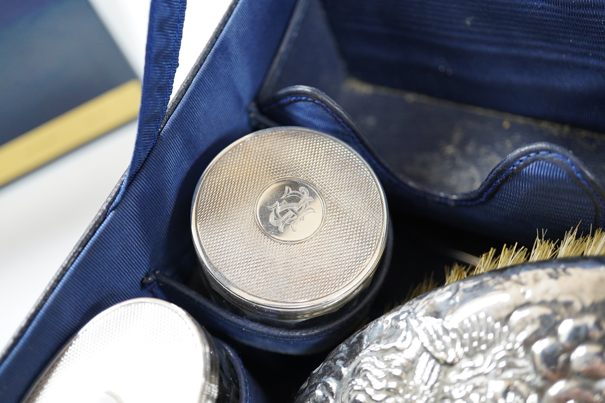 A small George V silver mounted travelling toilet set, various dates, patterns and makers. Condition - poor to fair
